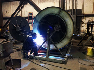 Welding a washing machine basket.